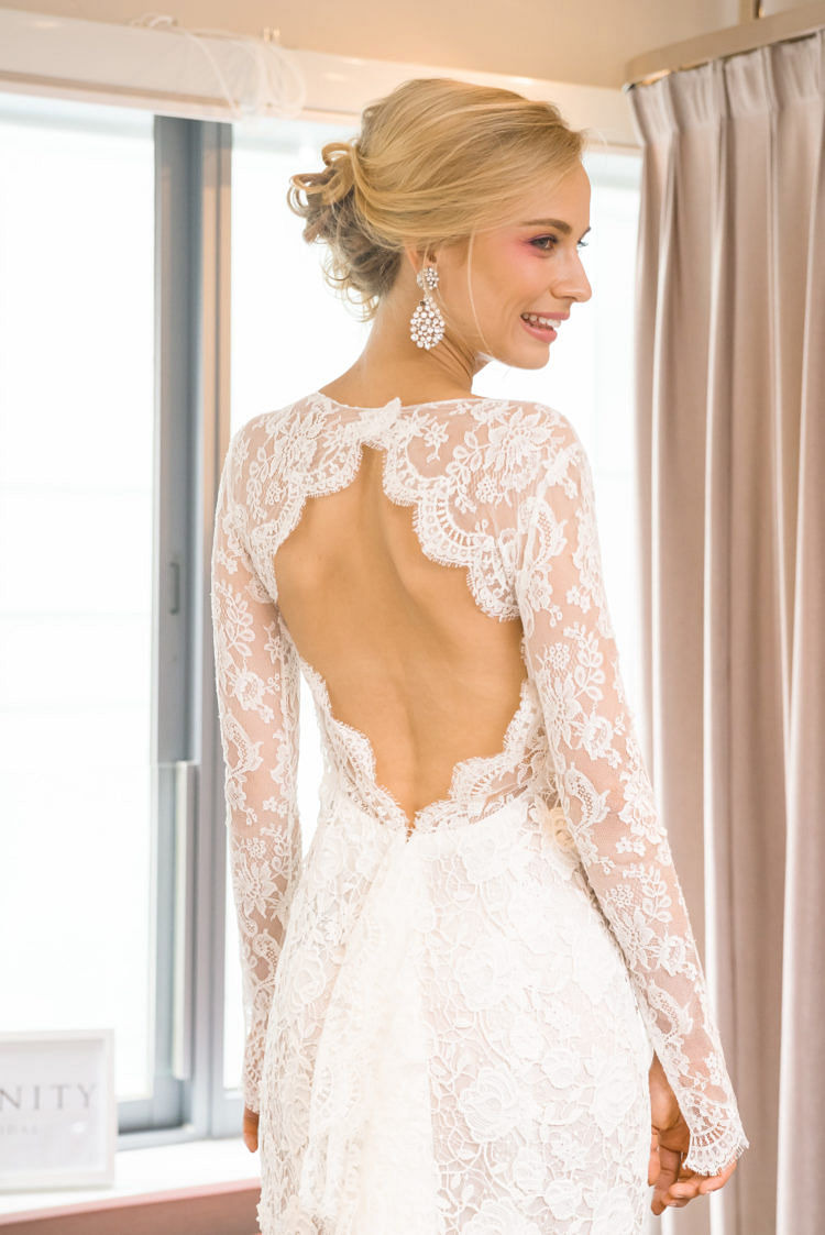 Long sleeve macrame and chantilly lace gown with jewel neckline and open back.