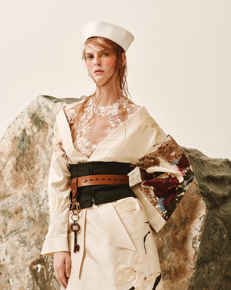 Silk coat and lace dress, Valentino. Leather belt, metal and leather charms (on belt), and wool corset, Prada